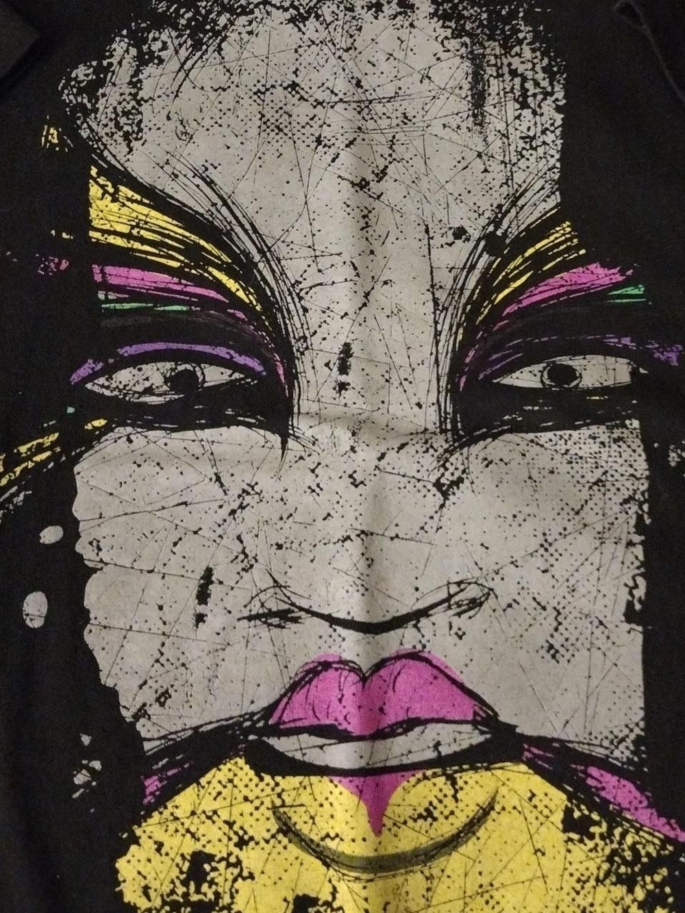 WWE Black T‑Shirt with White Face Graphic and Pink, Yellow, Purple Accents